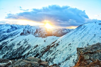 Scenic view of snowcapped mountains against sky during sunset