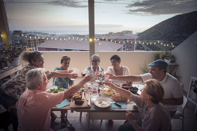 Family toasting drinks in restaurant