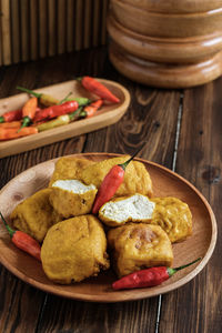 Fried yellow tofu in wooden plate