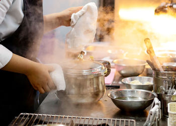 Midsection of man preparing food in kitchen