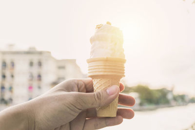 Close-up of hand holding ice cream cone