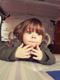 Close-up of cute baby girl wearing warm clothing while sitting in vehicle