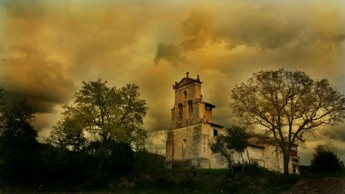 Built structure against cloudy sky at sunset