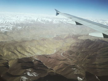 Aerial view of airplane wing against sky