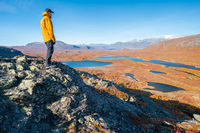 Rear view of man walking on mountain