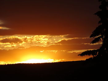 Scenic view of silhouette landscape against romantic sky at sunset