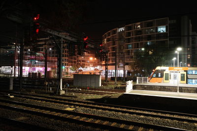 Train on railroad station platform at night