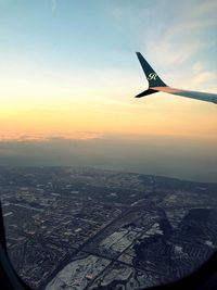 Aerial view of city against sky during sunset