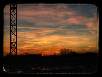 Silhouette of tower against dramatic sky