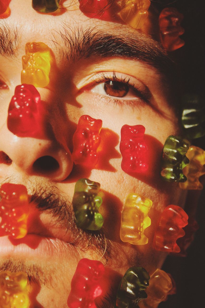 red, sweetness, indoors, one person, close-up, flower, portrait, food and drink, multi colored, food, adult