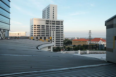 Building by street against sky in city