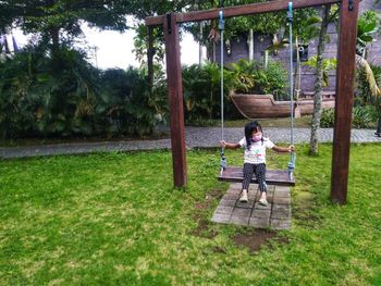 Boy sitting on seat in park