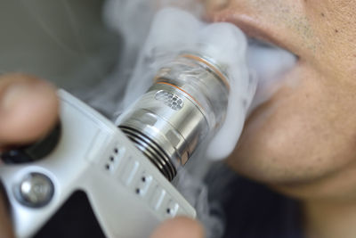 Close-up of man smoking electronic cigarette