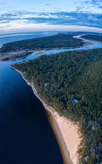 Aerial view of land and sea against sky