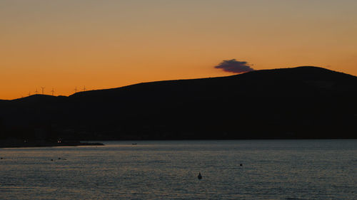 Scenic view of sea against orange sky