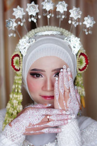 Portrait of beautiful smiling young woman in traditional bride clothing