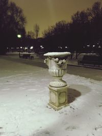 Illuminated lamp in park during winter at night