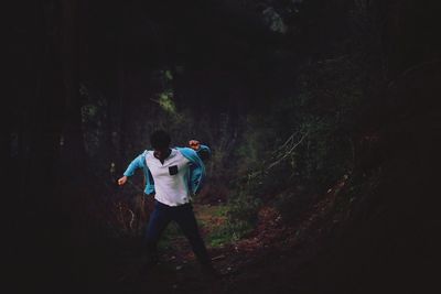 Man standing on tree trunk