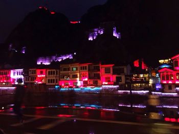 Illuminated city against sky at night