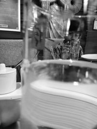 Reflection of wine glass on table in cafe