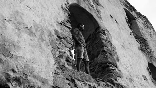 Low angle view of man standing in arch on wall at brahehus