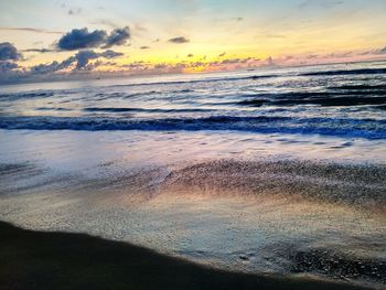 View of beach against cloudy sky