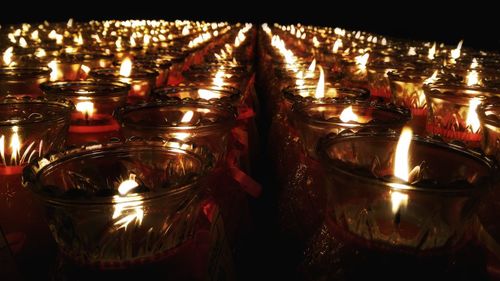 Close-up of illuminated candles in temple