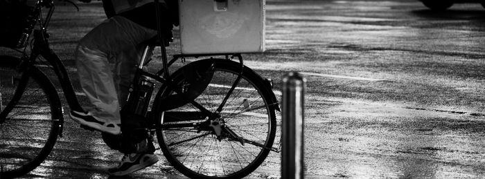 Low section of man with bicycle on footpath