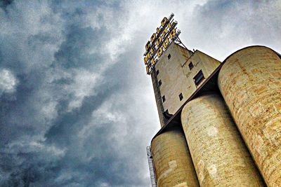 Low angle view of building against cloudy sky