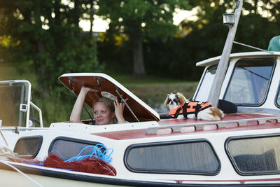 Woman on boat looking through hatch