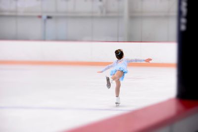 Full length of girl ice-skating