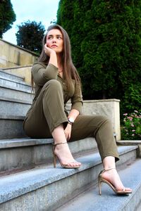 Portrait of young woman sitting on seat