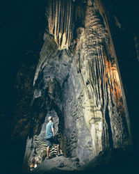 Unidentified tourist inside the grotto of the church of bom jesus da lapa, bahia