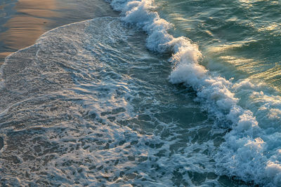 High angle view of waves rushing towards shore