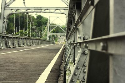 Railroad tracks by bridge in city