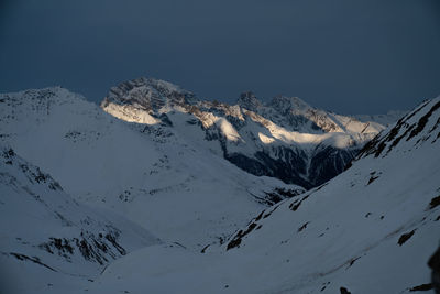 Scenic view of snowcapped mountains against clear sky