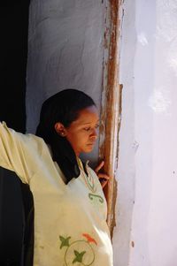 Side view of young woman standing outdoors