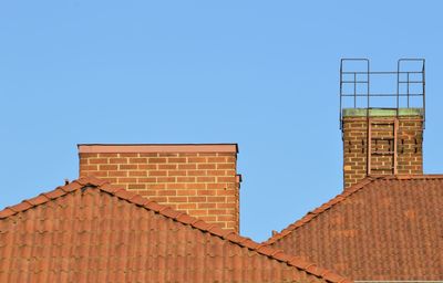 Low angle view of building against clear blue sky