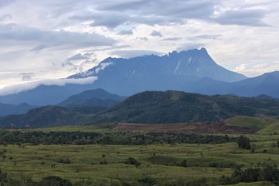 Scenic view of landscape and mountains against sky