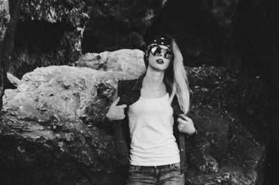 Portrait of a young woman standing on rock