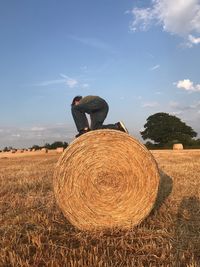 Hay bales on field against sky