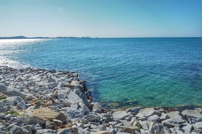 Scenic view of sea against clear blue sky