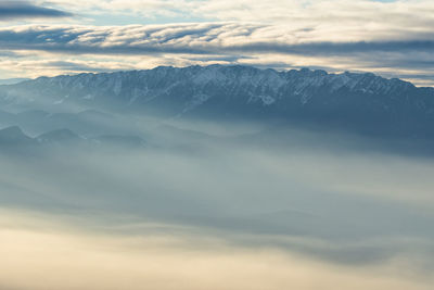 Scenic view of snowcapped mountains against sky during sunset