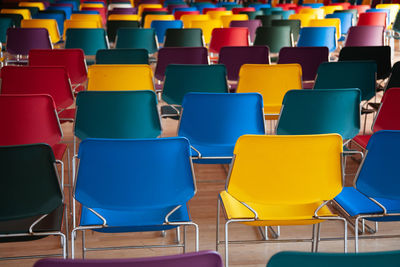 Empty chairs and tables arranged in row