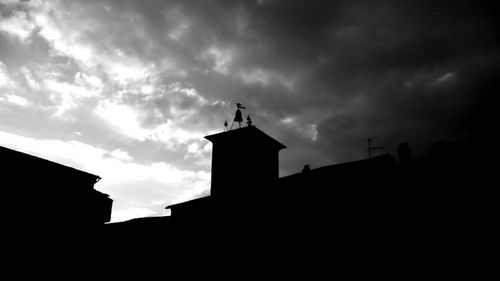 Low angle view of building against cloudy sky