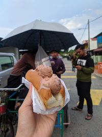 Midsection of people holding ice cream