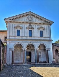 Low angle view of old building against clear blue sky