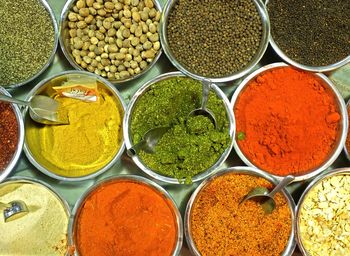 High angle view of various spices in bowls on table