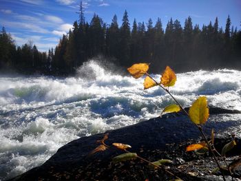 Scenic view of waterfall against sky during winter