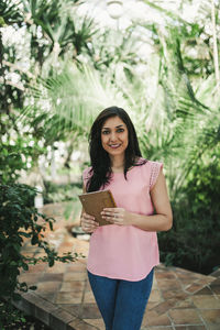 Corporate portrait of a beautiful agronomical engineer in a greenhouse